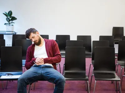 Guy asleep in a confernce room after everyone left