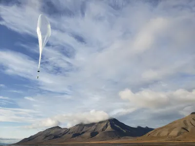 Windborn weather ballon heading up.