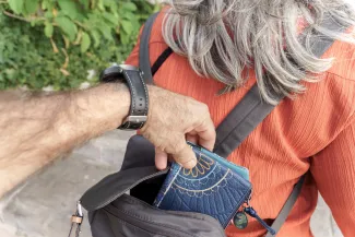 Pickpocket taking wallet from backpack