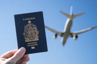 Canadian Passport, with jet flying over.